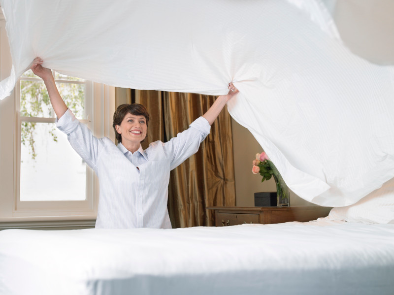 woman-toss-cotton-sheet